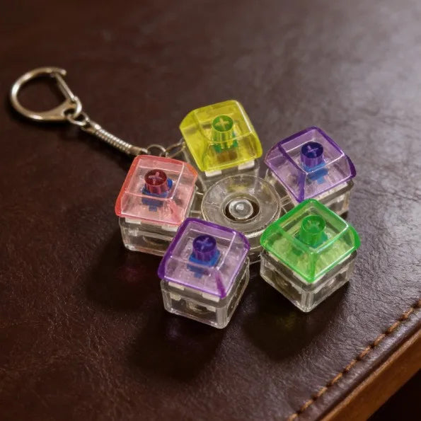 A collection of colorful, translucent LED keyboard fidget toys attached to a silver keychain ring.