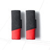 A pair of black and red car roof handle covers made of Alcantara fabric.