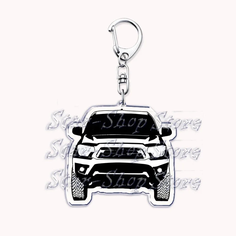 Silver acrylic keychain featuring a detailed off-road truck model.