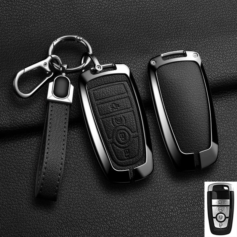 A black aluminum alloy key fob cover with a leather strap and keyring is shown against a dark background.