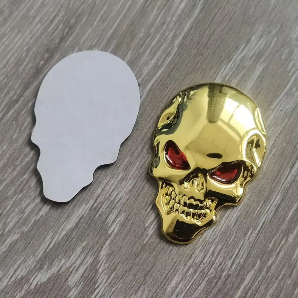 A shiny gold skull emblem badge next to a white silhouette of a human head.