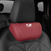 A red ergonomic neck pillow with an F Sport logo is placed on a black car seat.
