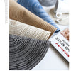 A collection of various colored and textured yarn skeins laid out on a white surface.