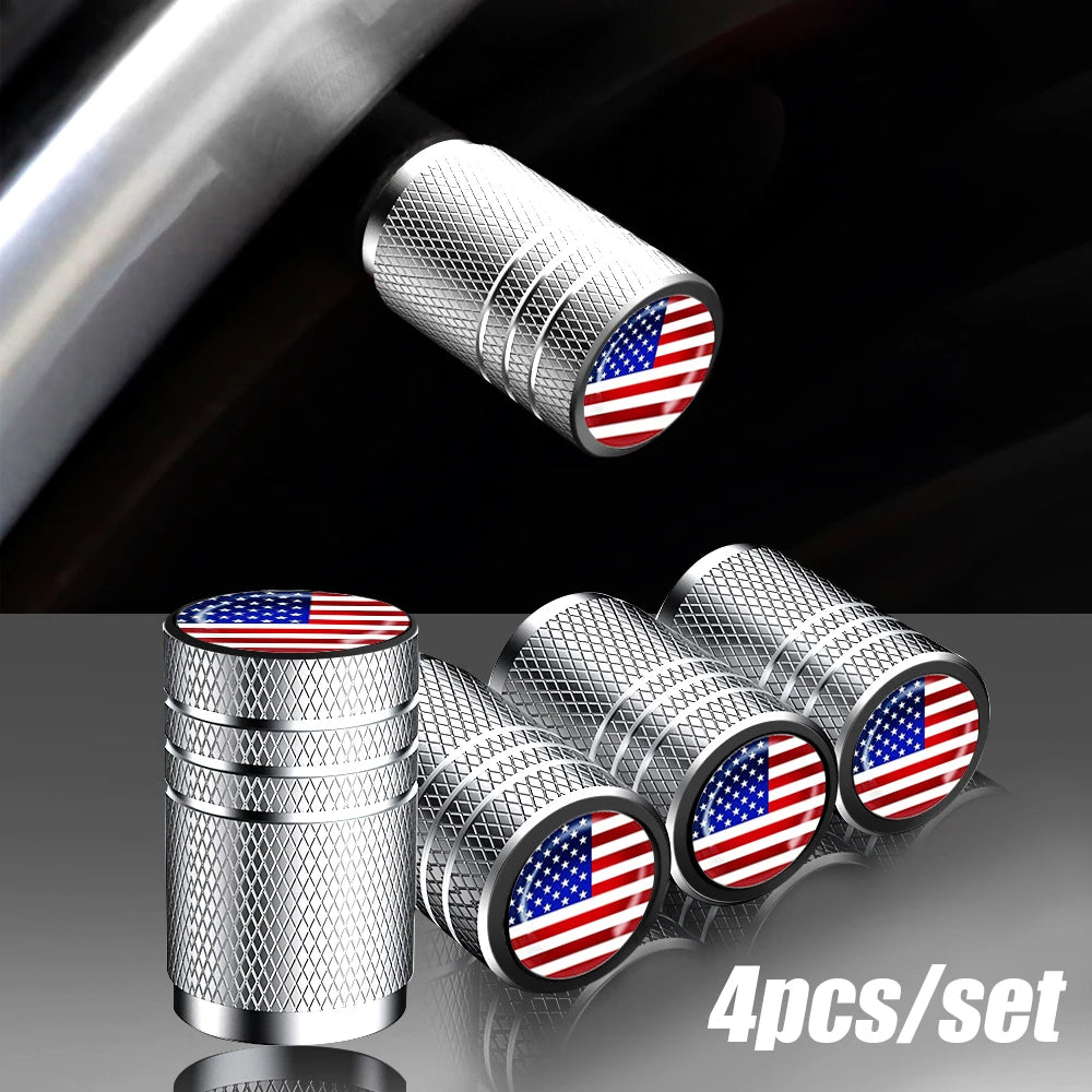 A set of four silver aluminum tire valve caps featuring the American flag design.