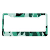 A rectangular license plate cover with a camouflage pattern featuring green and dark green colors.