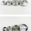A row of five modern stainless steel pendant lamp fittings or caps.