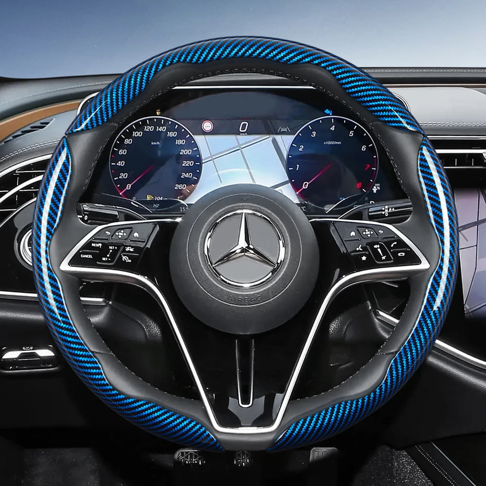 Close-up view of a black steering wheel with blue carbon fiber texture accents and a Mercedes-Benz emblem.