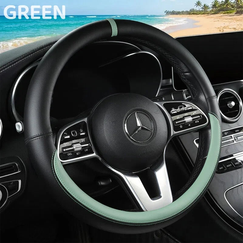 A black steering wheel with a light green leather cover is visible inside a car cabin.