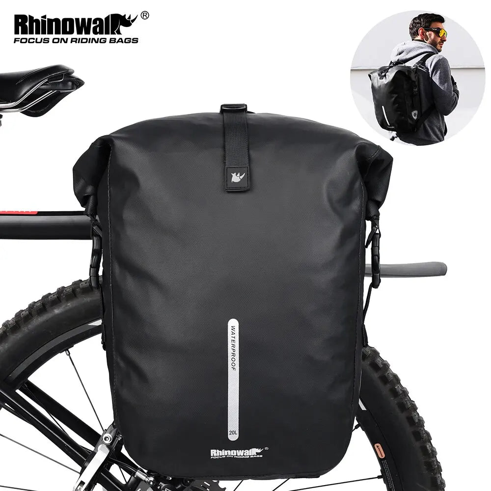 A black waterproof bike pannier bag is shown mounted on a bicycle frame.
