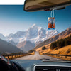 A multi-scent hanging air freshener is visible hanging from a rearview mirror inside a car, with a scenic mountain landscape 