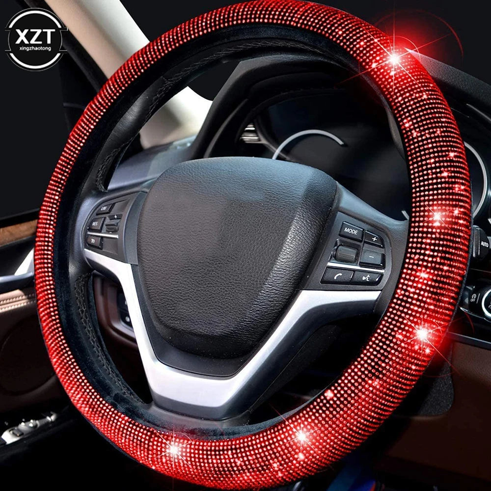 A close-up view of a car steering wheel covered in sparkling red rhinestones.