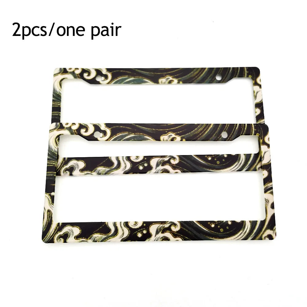 Two license plate frames with a marbled black and gold design, sold as one pair.