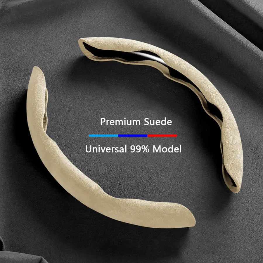 A beige suede steering wheel cover with a black trim is shown against a dark background.