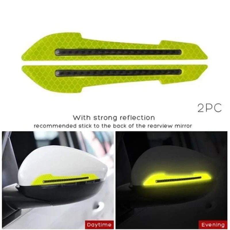 Two bright yellow reflective strips recommended to be stuck to the back of a rearview mirror