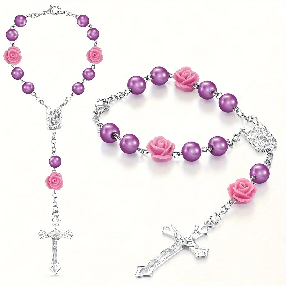 A silver Catholic rosary featuring purple rose beads and a cross pendant with pink rose accents.