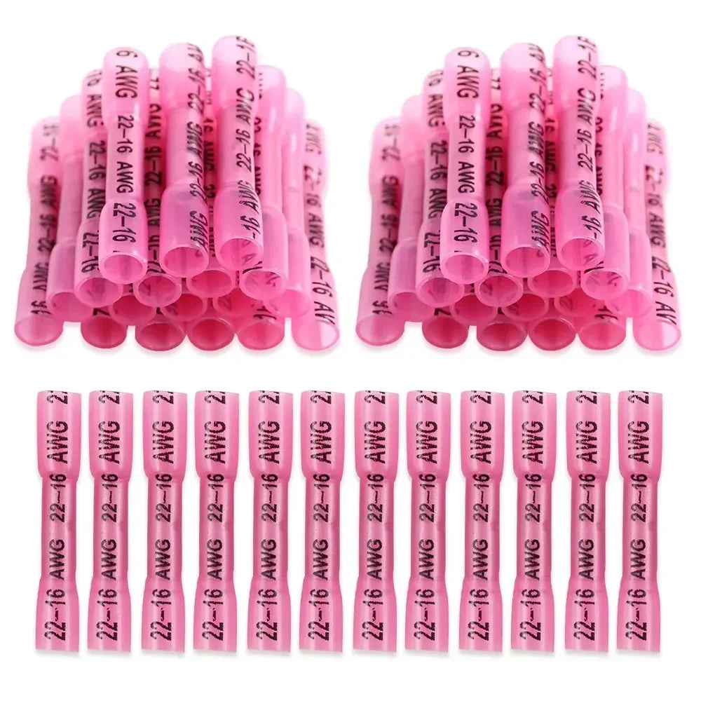 A collection of pink and clear durable heat shrink wire connectors arranged in rows.