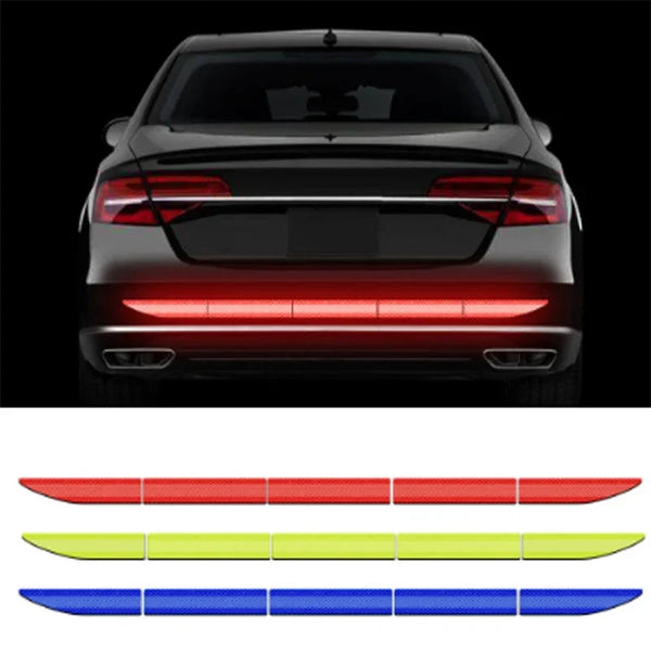 A rear view of a car with five reflective safety stickers in red, yellow, and blue arranged horizontally.