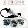 An automotive spark plug ignition tester kit with a clear glass tip and black handle, shown next to performance engine and gl