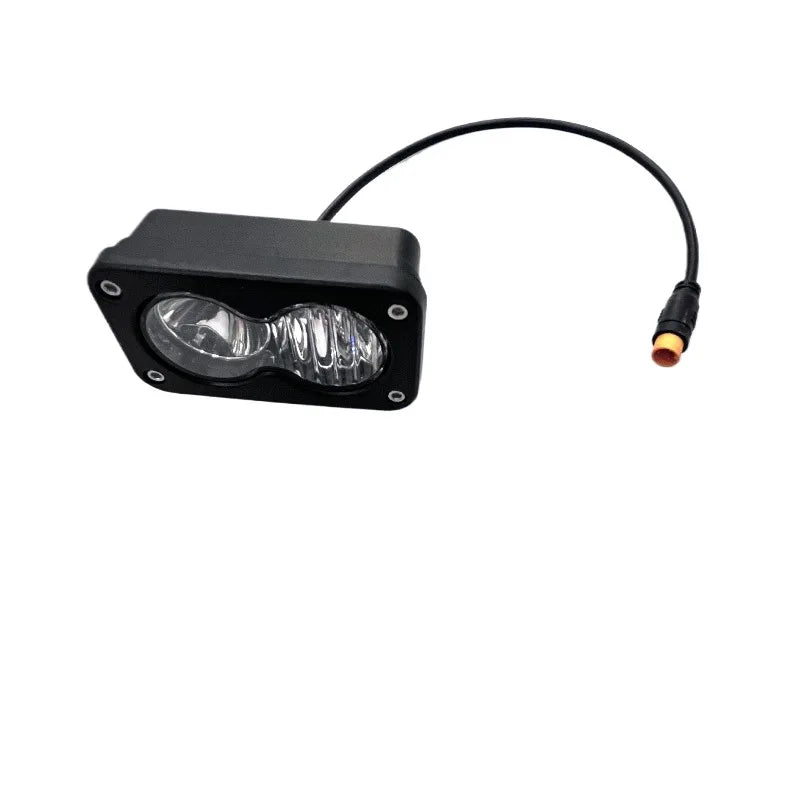 A black 3-inch LED pod spotlight with a wire connector for motorcycle offroad headlights.