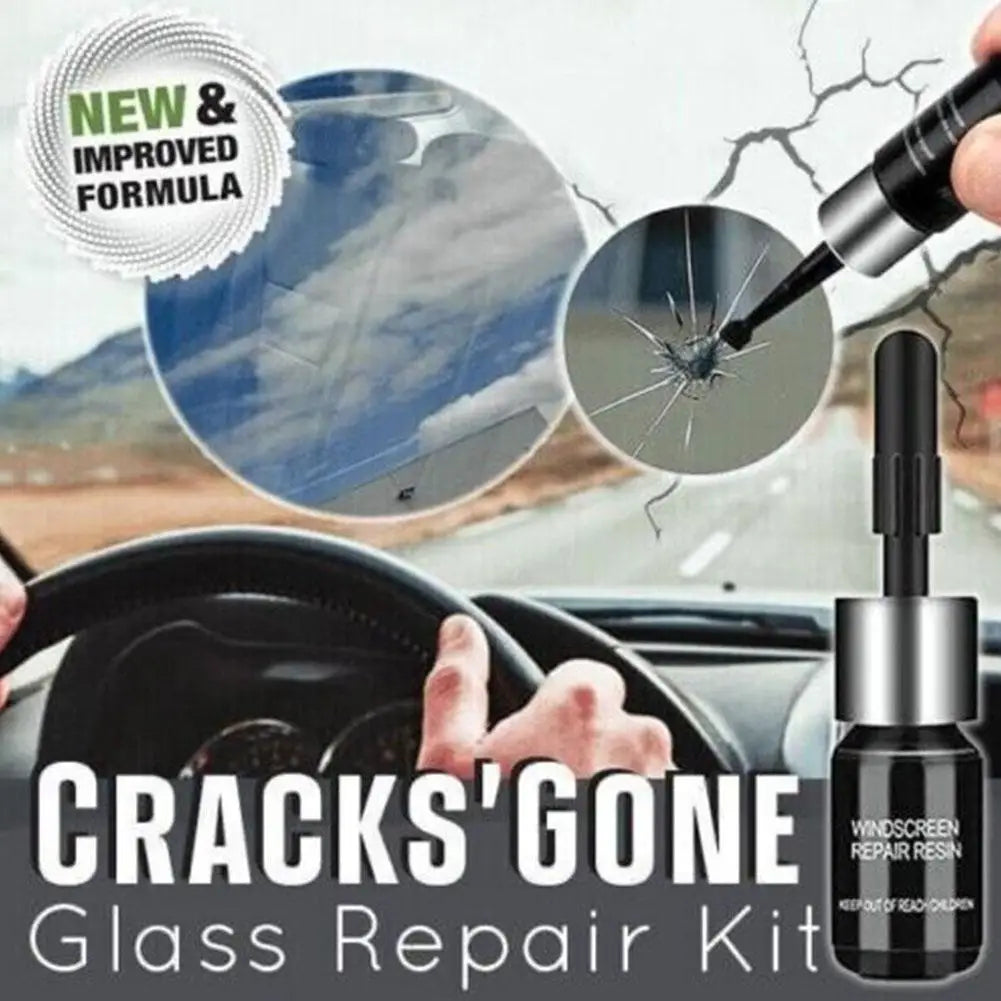 A close-up of a hand applying repair resin to a cracked car windshield glass.