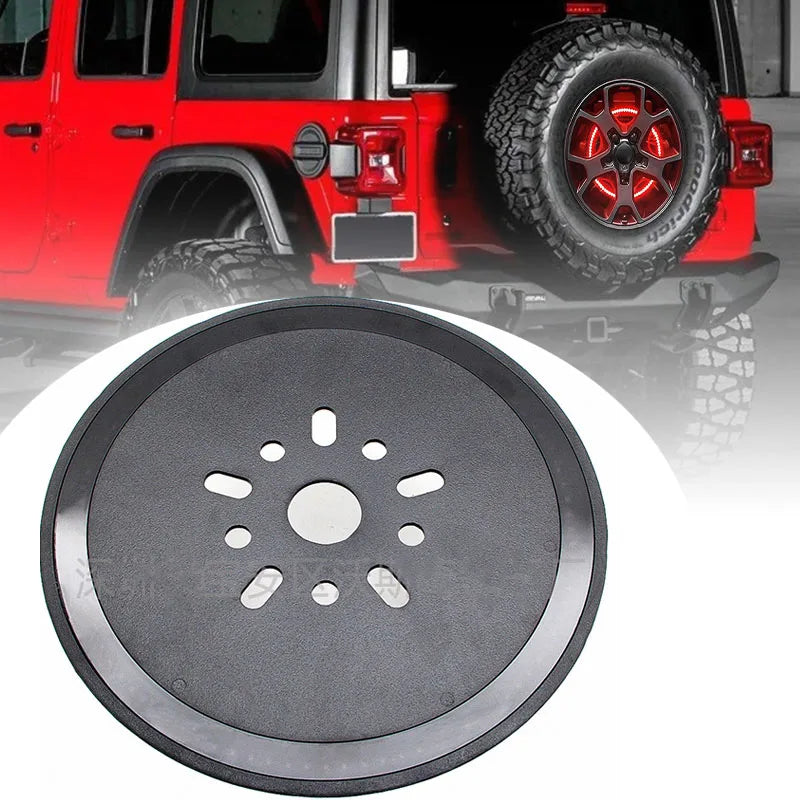 A close-up view of a round black third brake light for a Jeep Wrangler.
