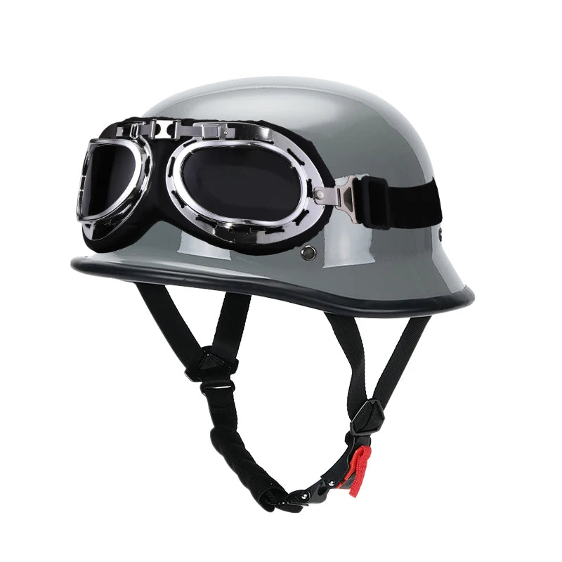 A gray half-helmet with a clear visor and black strap harness for motorcycle or EV safety gear.