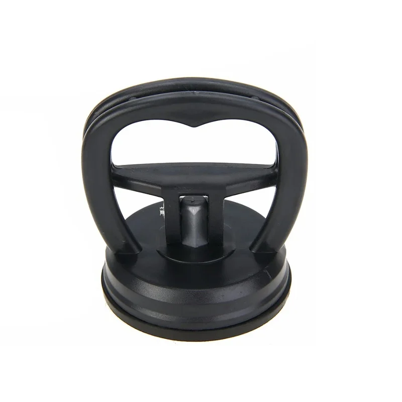 A black suction cup dent puller tool with a handle and base for bodywork repair.