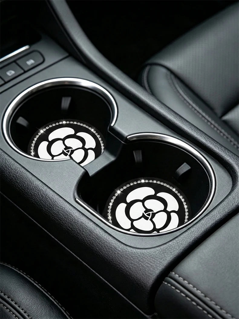 Close-up of car cup holders with decorative non-slip coasters visible in the interior