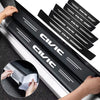 Black carbon fiber door sill protectors installed on a vehicle's side, showing the texture and design.