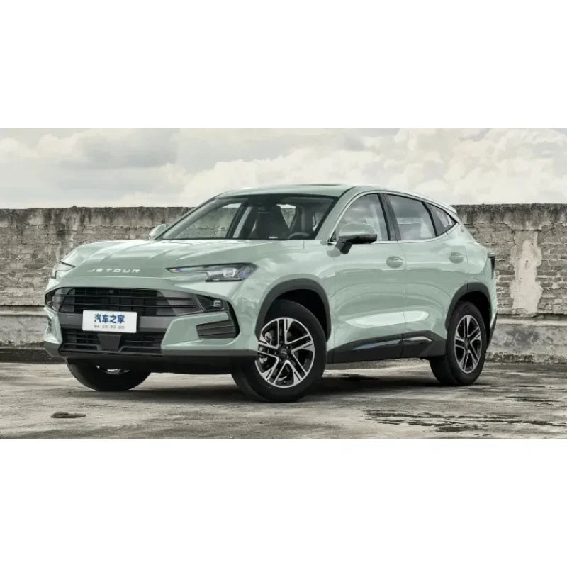 A light green SUV is parked outdoors against a stone wall.