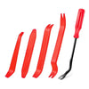 A set of red plastic tools for removing car trim, including a lever and a scraper.