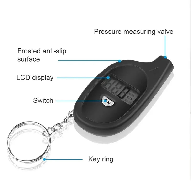 A black digital tire pressure gauge with a measuring valve, LCD display, switch, and key ring attached.