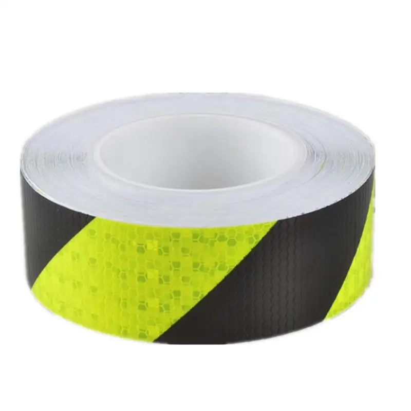 Roll of high-visibility fluorescent yellow reflective safety tape on a black background