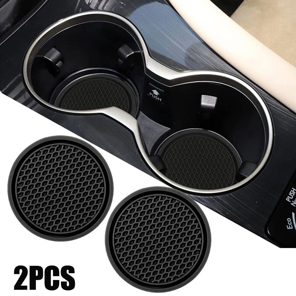 Dos insertos de soporte para vasos de silicona negra para coche, mostrados con el portavasos principal.