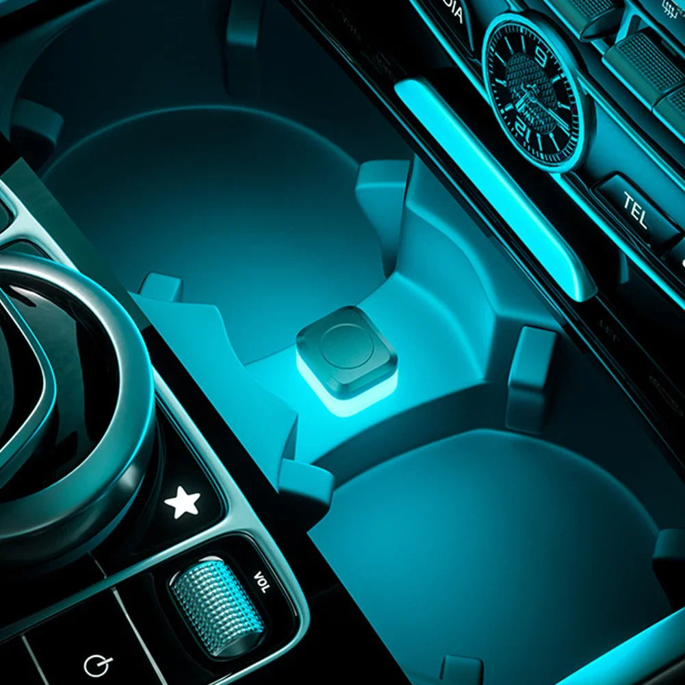 Close-up view of a car interior featuring blue ambient LED lights and controls.