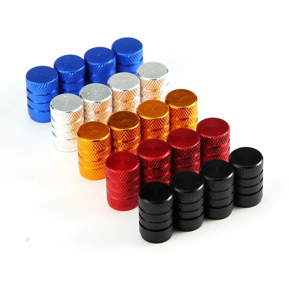 A collection of aluminum tire valve caps in various colors including blue, silver, gold, and red.