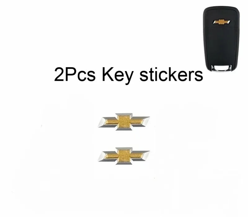 Two aluminum Chevrolet key emblem stickers displayed against a white background.