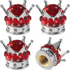 A set of silver tire valve caps decorated with red rhinestones and a diamond-shaped top.