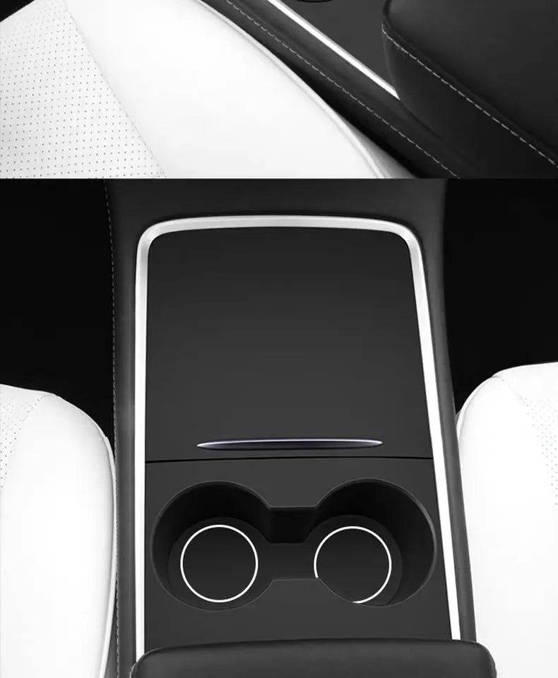Interior view of a car dashboard featuring a black panel with circular controls and white leather upholstery.