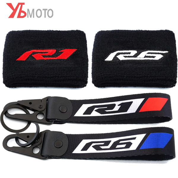 Black and white silicone covers for motorcycle brake fluid reservoirs featuring red and blue R1 and R6 logos