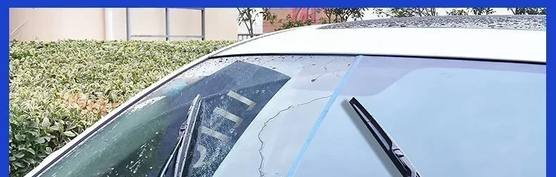 Close-up view of a car window with rain repellent spray applied, showing water beading on the glass.