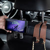 A hand holds a smartphone displaying a text message while attached to universal car seat headrest hooks.