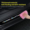 A hand wipes a black car door sill protector vinyl decal with a pink cleaning cloth.