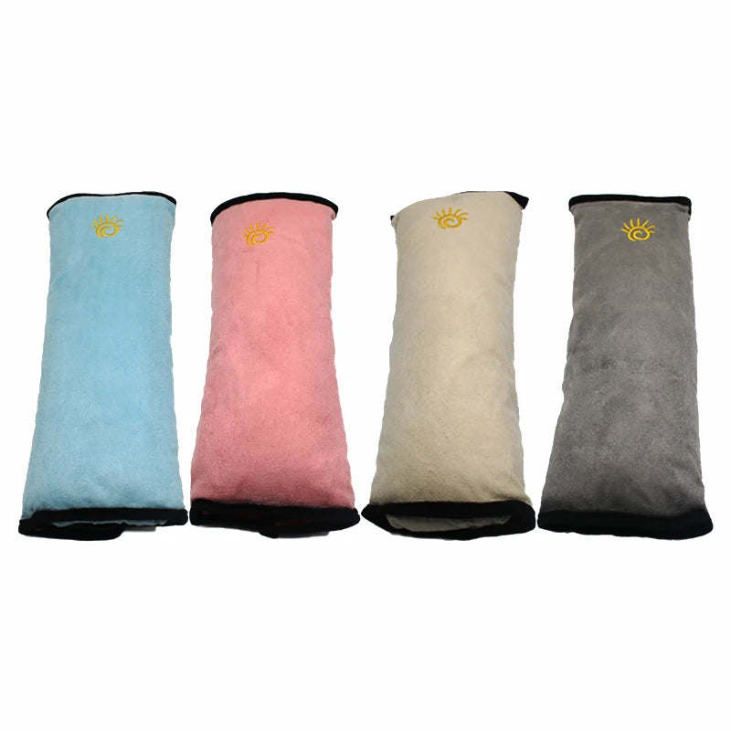 Four colored car seat belt shoulder cushions in light blue, pink, beige, and gray.