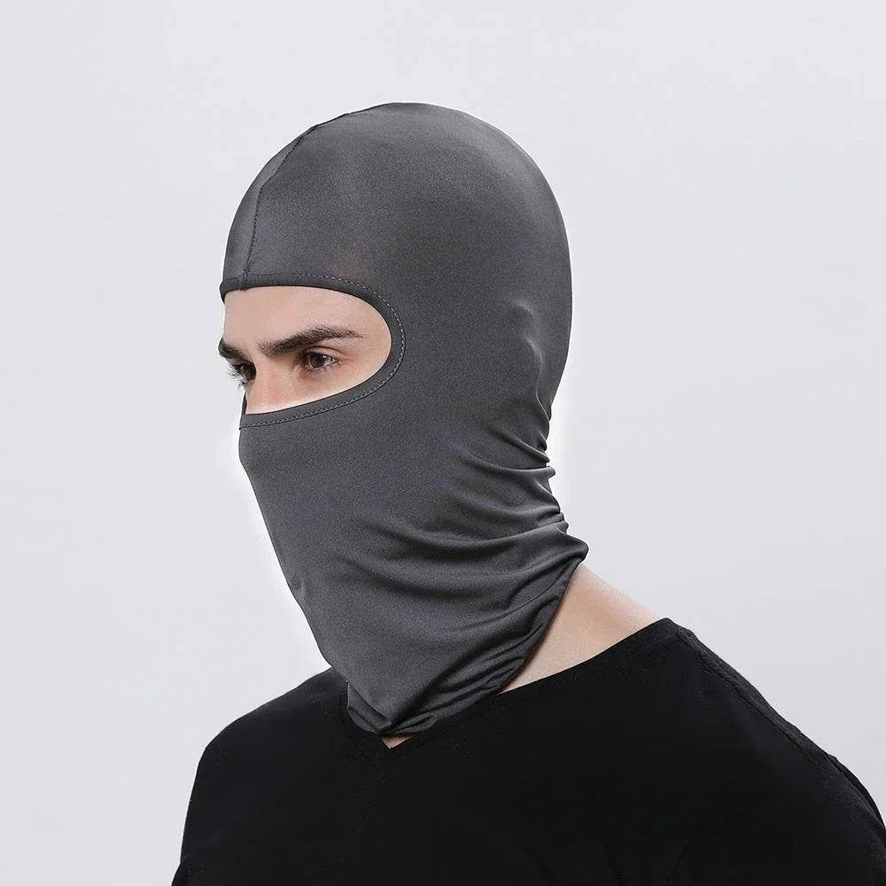 A man wearing a dark gray all-weather windproof balaclava face mask.