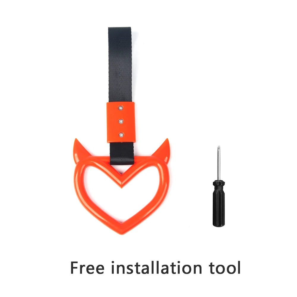 Black strap with an orange hand pull ring and a metal tool for installation