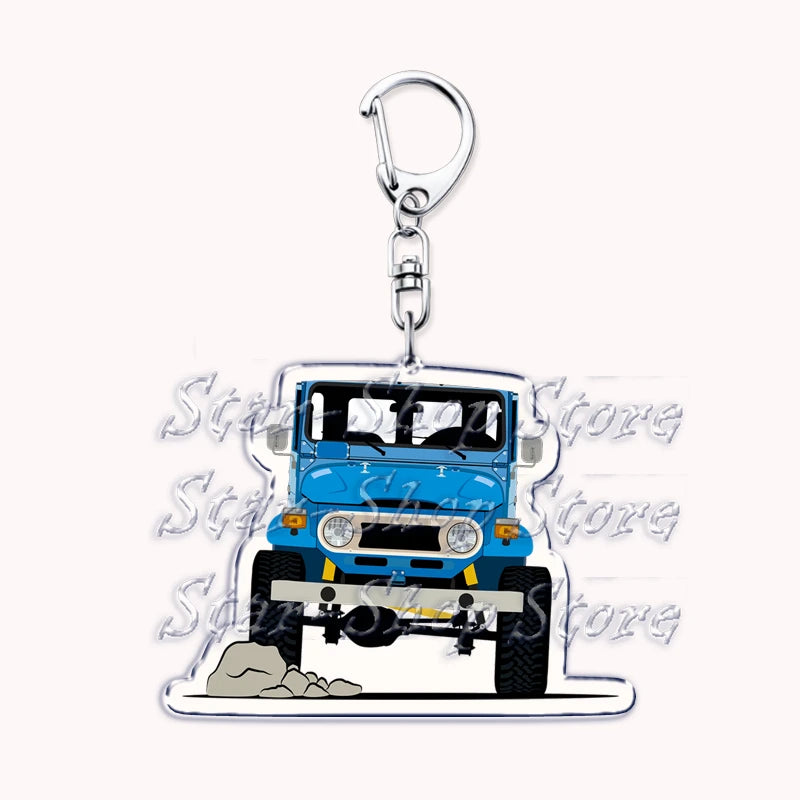 A clear acrylic keychain featuring a blue off-road truck with a front view.