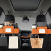 A car back seat organizer featuring cup holders and storage compartments for bags and items.