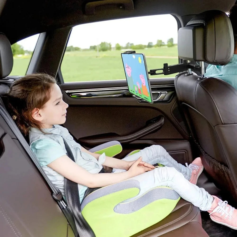 A young girl sits in a car, using a universal rotating mount to hold a phone and tablet on her headrest.