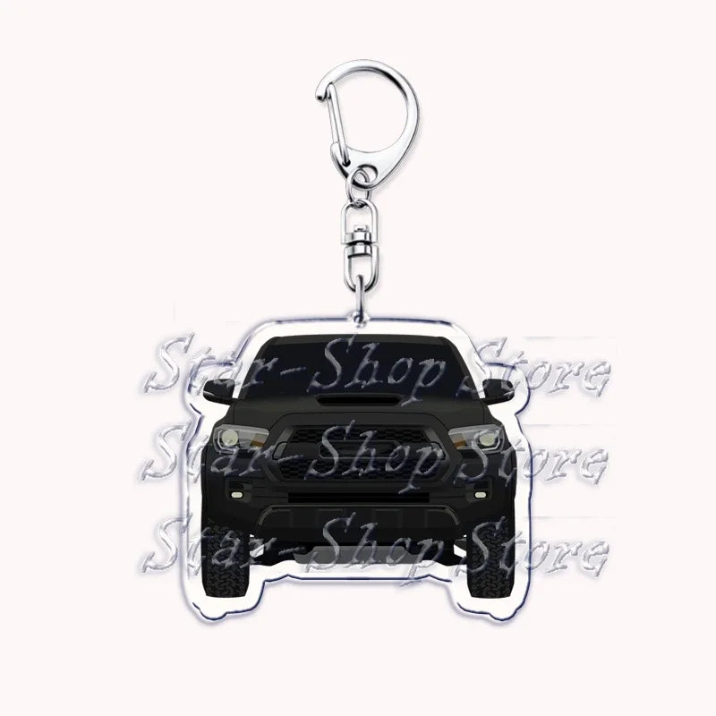 Silver acrylic keychain featuring a black off-road truck silhouette.